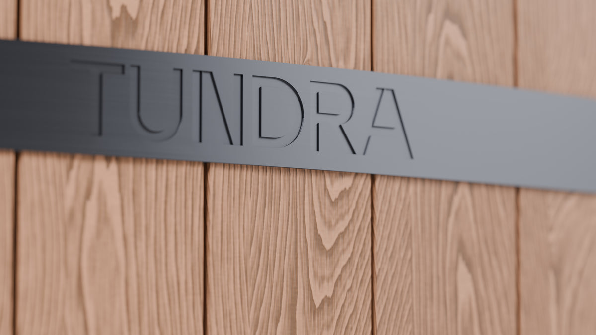 Close up of the TUNDRA wordmark engraved in the black band on the Inari WPC cladding