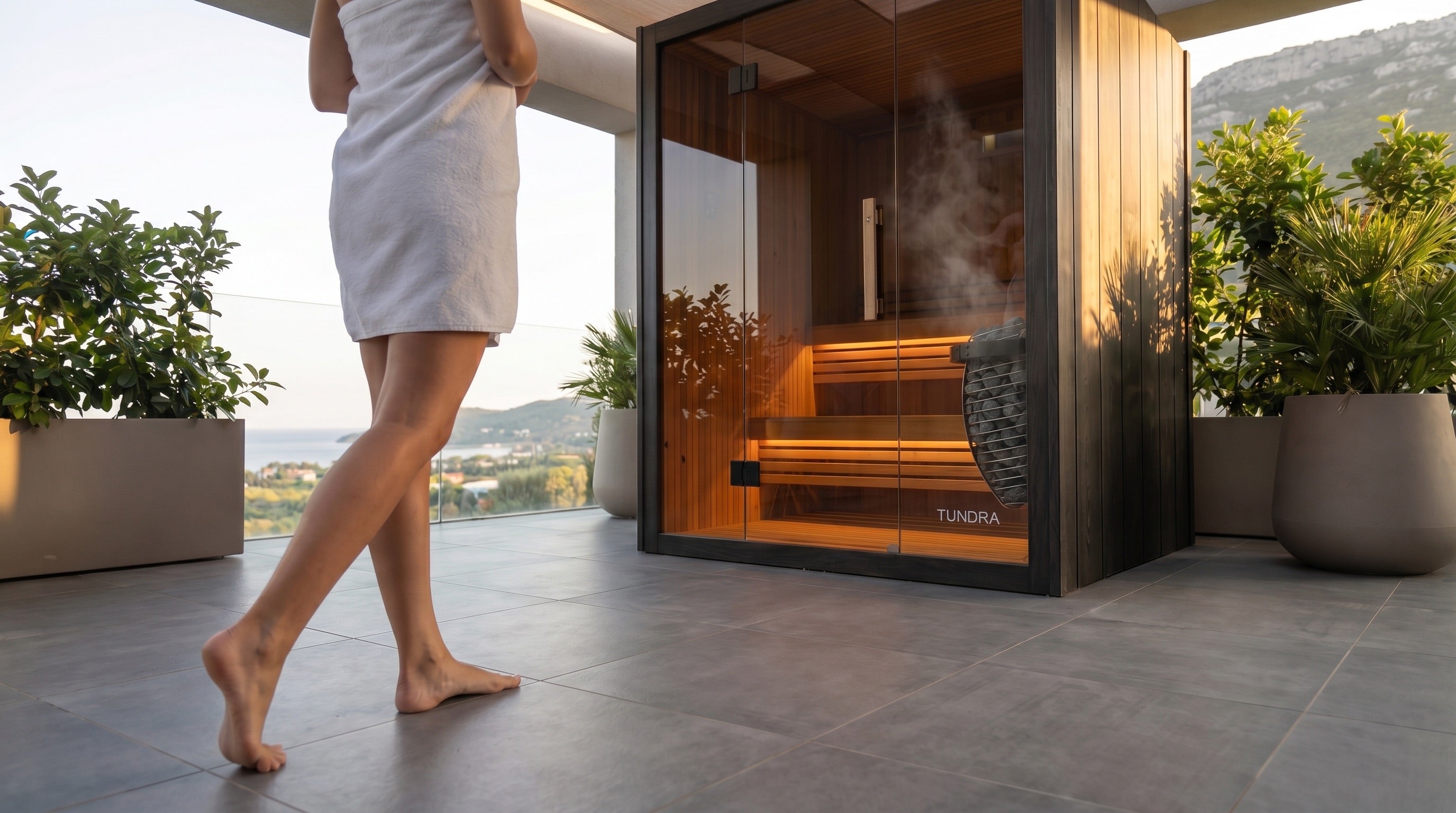 TUNDRA Haven outdoor sauna on a terrace with a person walking toward it