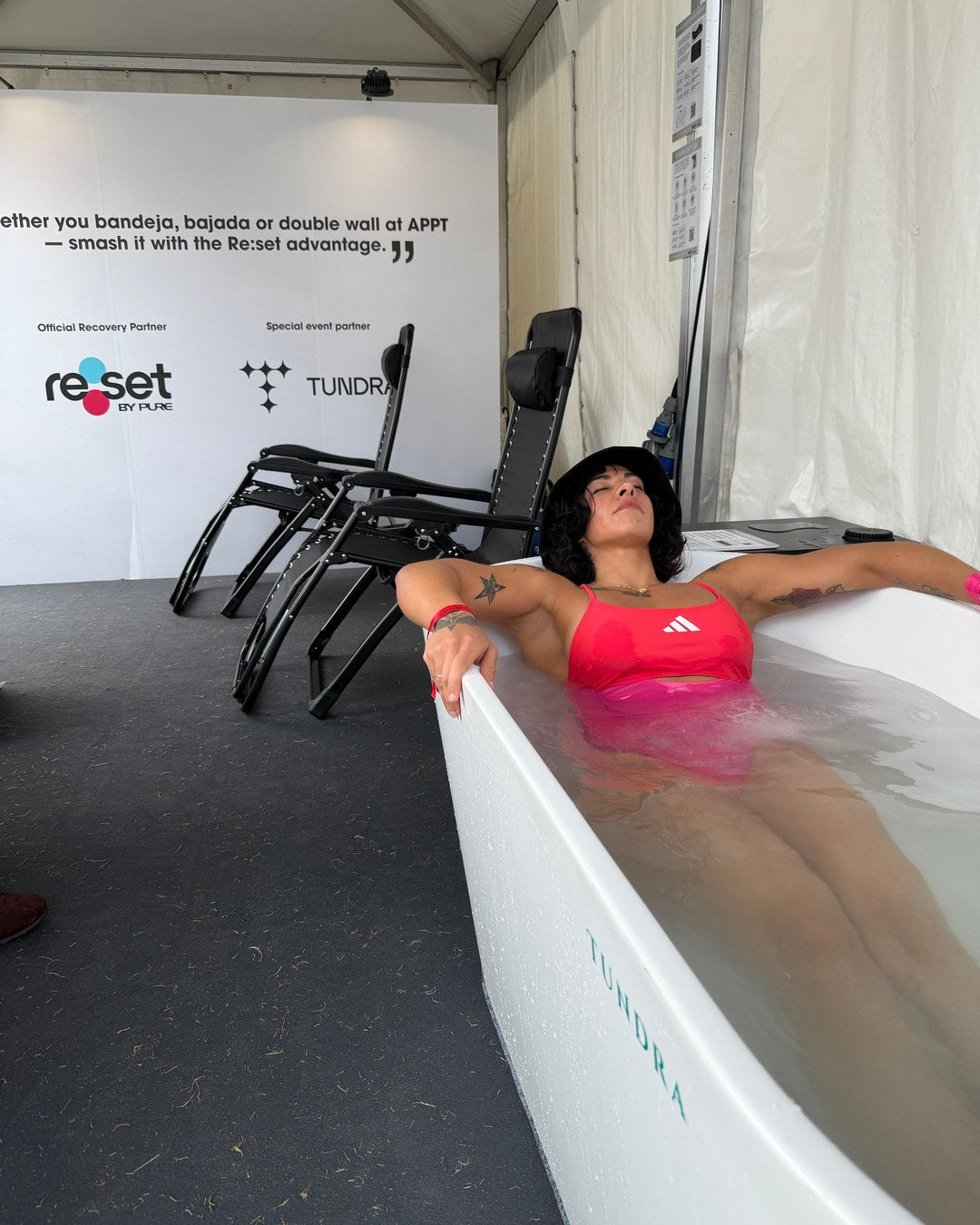 Athlete in a TUNDRA cold plunge at the APPT Hong Kong recovery lounge with re:set by PURE