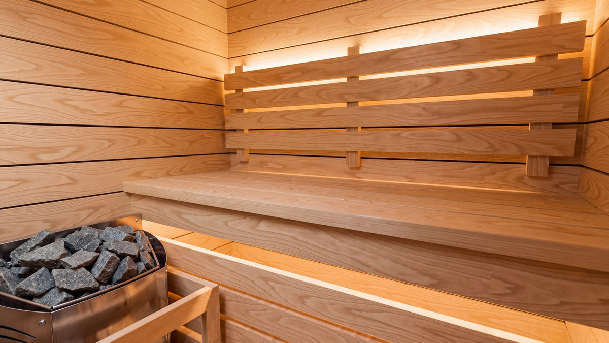 Inside the Ounas: two-tier spruce bench with backrest, warm LED light along the backrest and under the bench nose