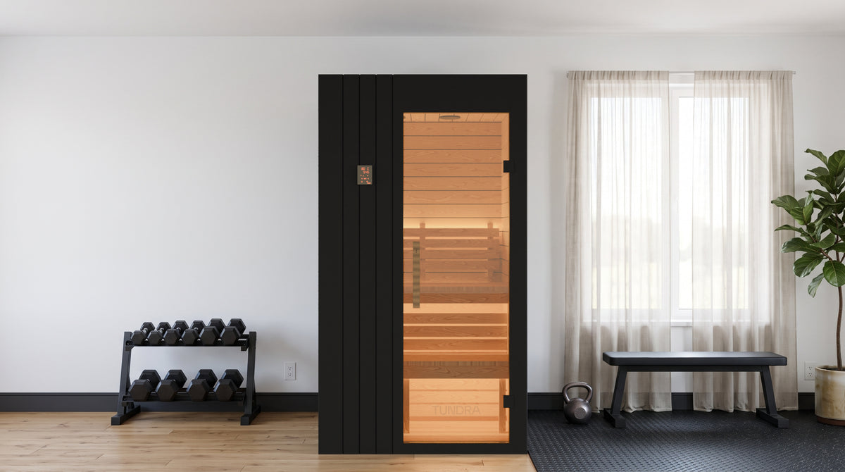 The Ounas for two against the wall of a home gym in a condominium, daylight from the window