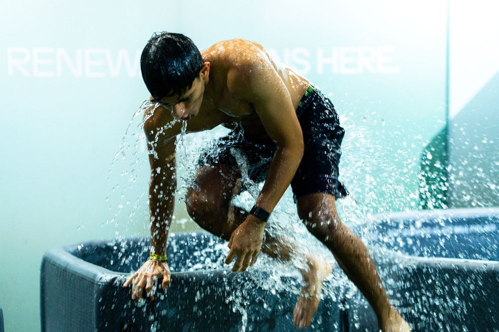 Athlete climbing out of a TUNDRA communal plunge at HYROX